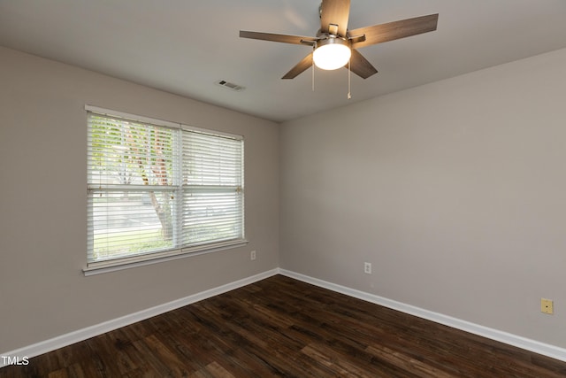 spare room with dark hardwood / wood-style floors and ceiling fan