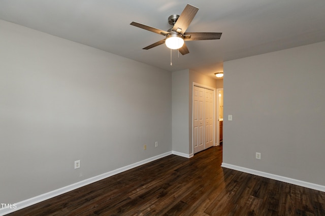 unfurnished room with ceiling fan and dark wood-type flooring