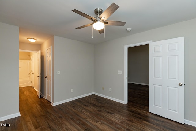 spare room with ceiling fan and dark hardwood / wood-style floors