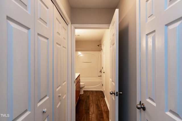 full bathroom with wood-type flooring, shower / bath combination, vanity, and toilet