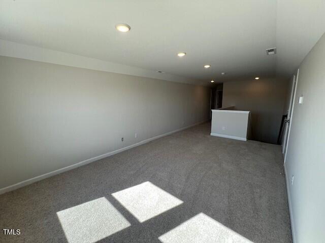 spare room featuring baseboards, carpet flooring, and recessed lighting