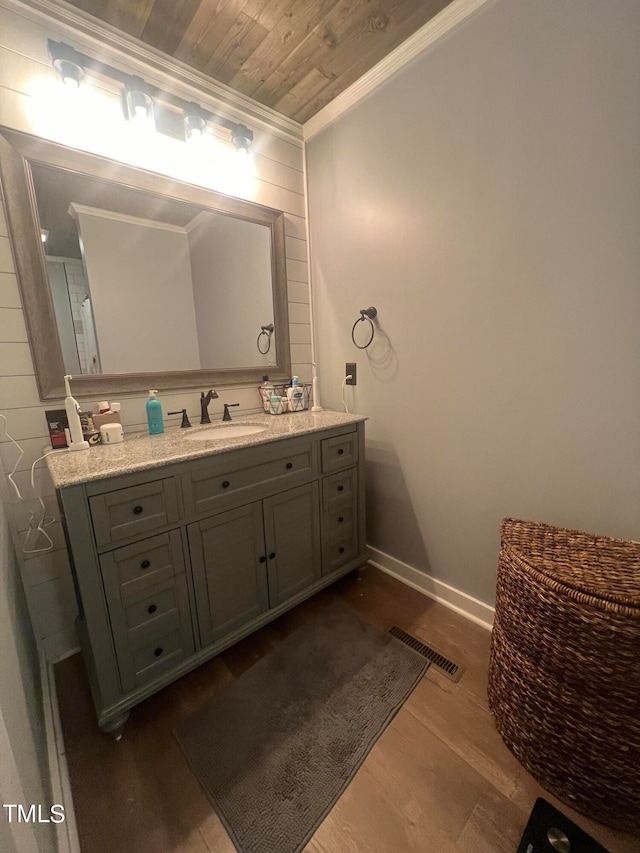 bathroom with wooden ceiling, ornamental molding, vanity, and hardwood / wood-style floors