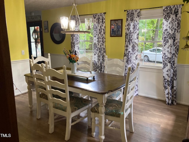 dining space featuring dark hardwood / wood-style floors and a notable chandelier