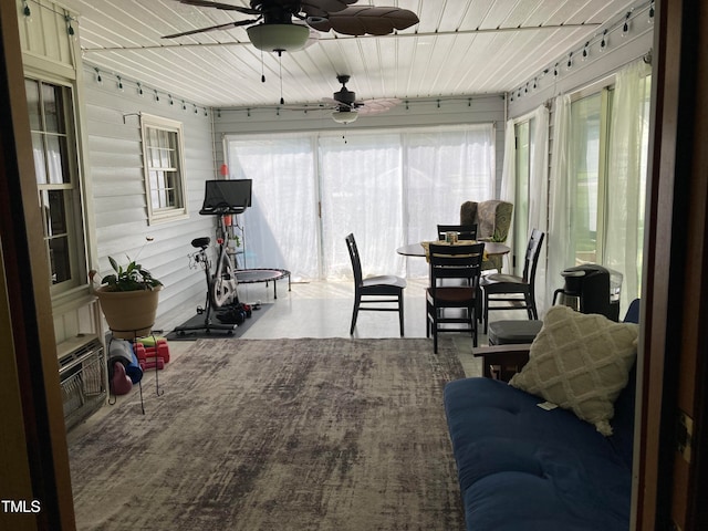 sunroom / solarium featuring wood ceiling and ceiling fan