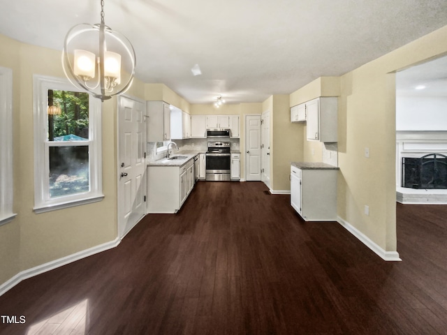 kitchen featuring pendant lighting, stainless steel appliances, and dark hardwood / wood-style floors