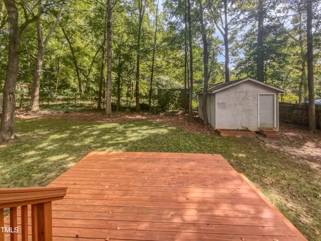 wooden deck featuring a yard and a storage unit