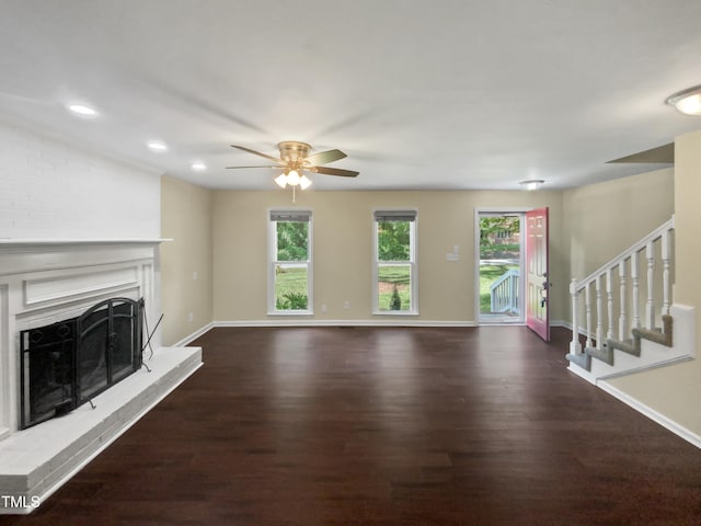 unfurnished living room featuring ceiling fan and dark hardwood / wood-style floors