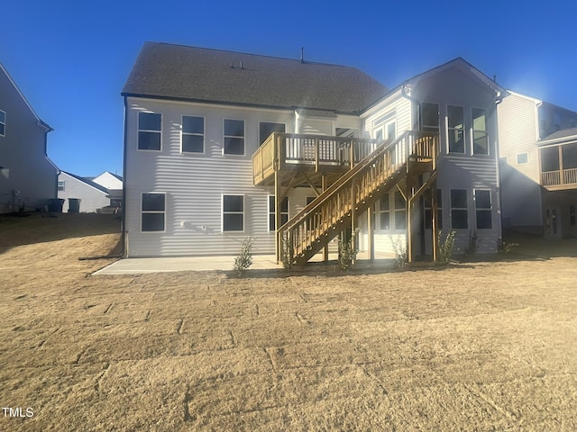 back of house with a patio area and a wooden deck