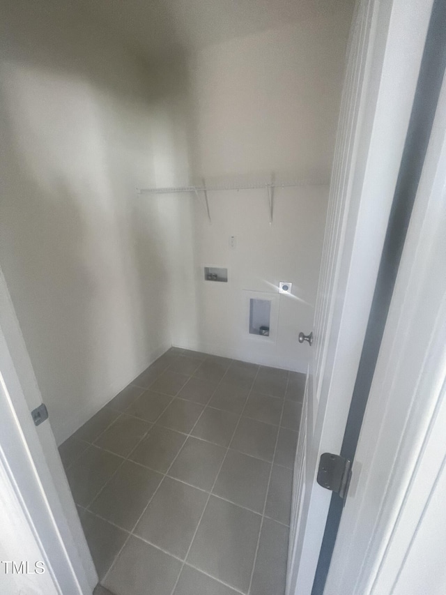 washroom featuring dark tile patterned floors, electric dryer hookup, and hookup for a washing machine