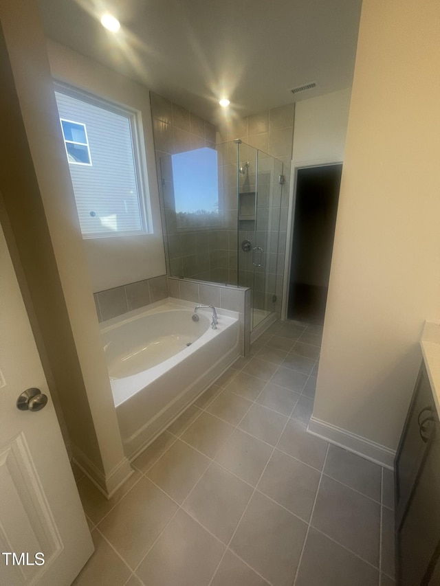 bathroom featuring vanity, tile patterned flooring, and plus walk in shower