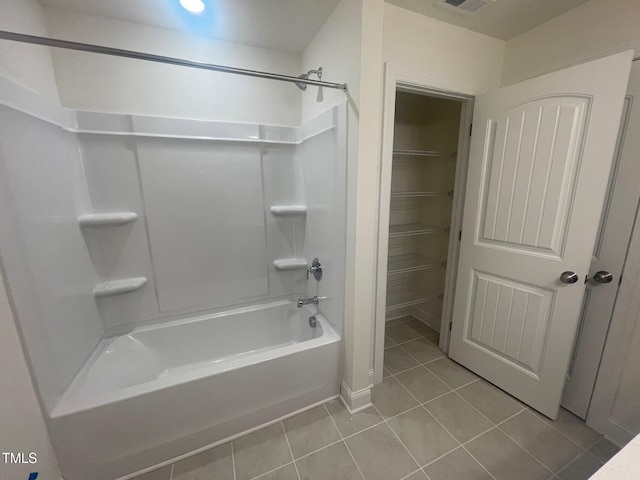 bathroom featuring washtub / shower combination and tile patterned floors