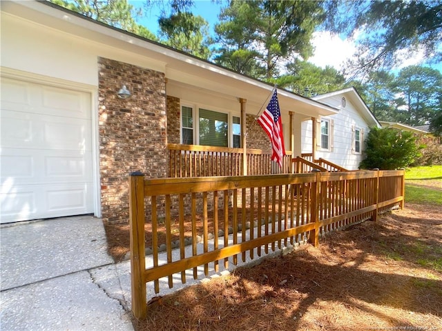 exterior space featuring covered porch and a garage