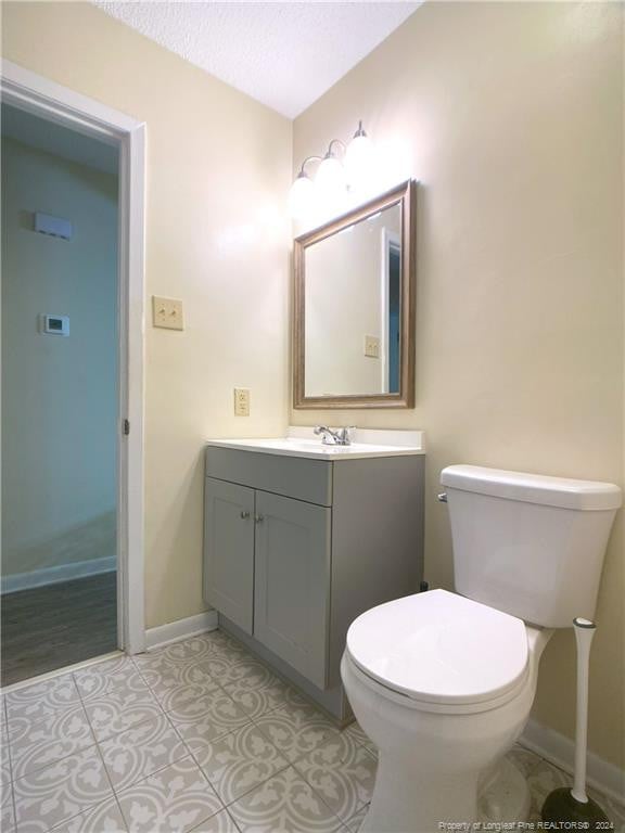 bathroom with tile patterned floors, vanity, and toilet