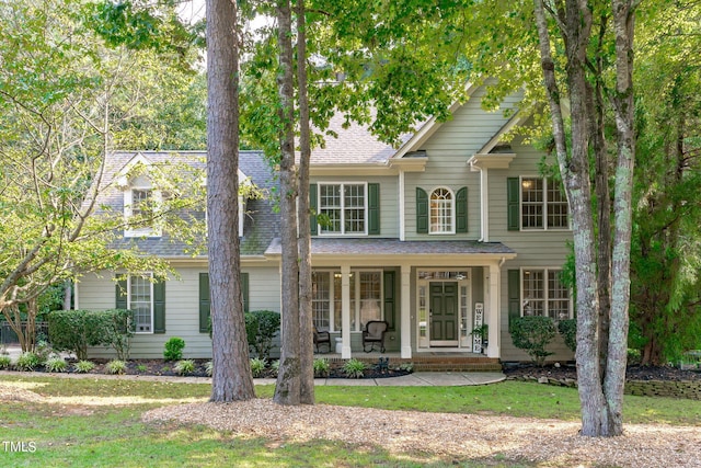 front of property featuring covered porch and a front yard