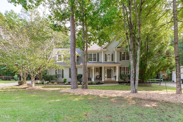 view of front of property with covered porch and a front yard