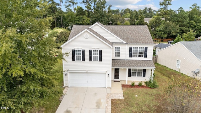 view of front property featuring a front lawn and a garage