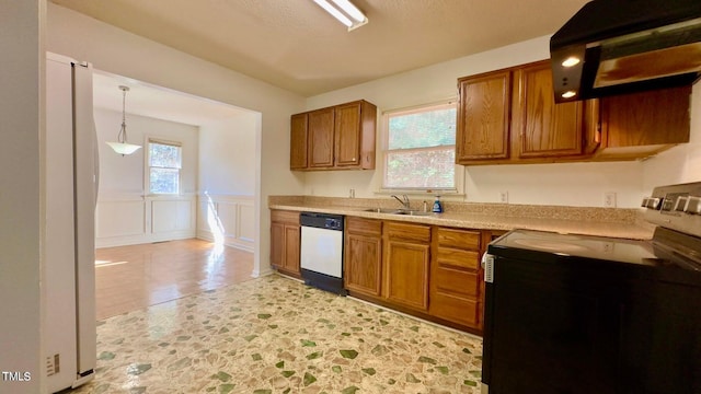 kitchen with pendant lighting, sink, white appliances, light hardwood / wood-style flooring, and range hood