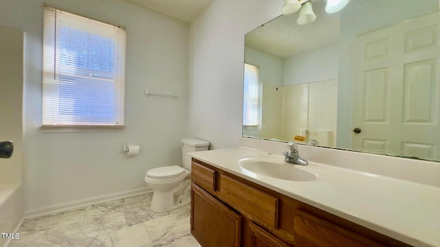 bathroom with vanity, toilet, a tub, and a wealth of natural light