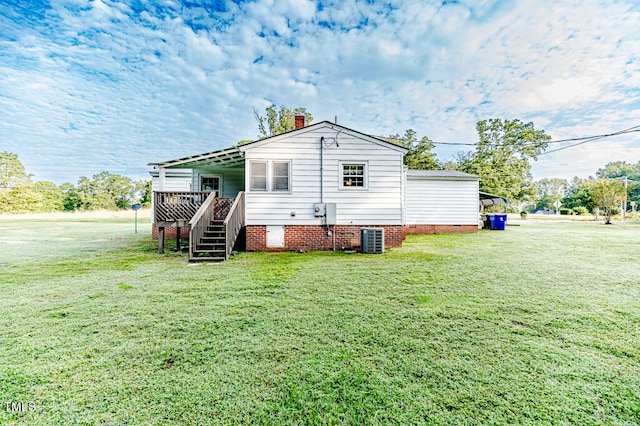 back of house with a yard and cooling unit