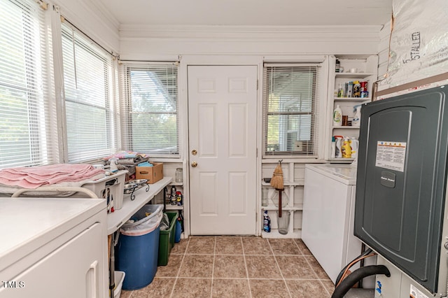 laundry room featuring crown molding, washer / dryer, and a healthy amount of sunlight