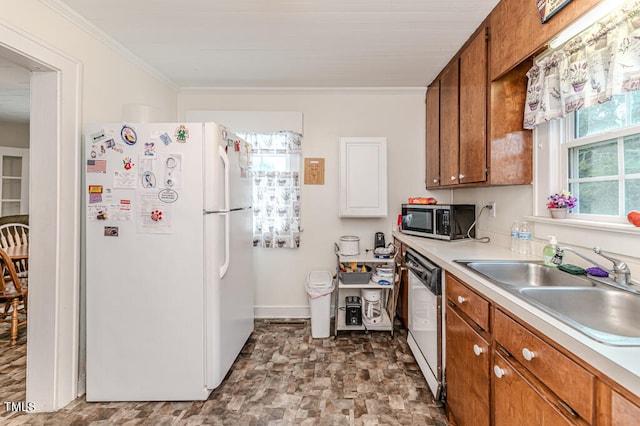 kitchen featuring appliances with stainless steel finishes, crown molding, and sink