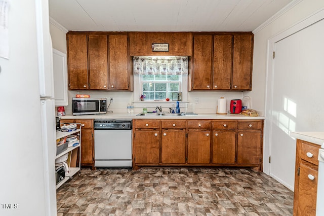 kitchen featuring ornamental molding, dishwasher, and sink