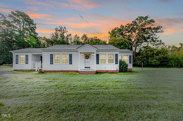 ranch-style house featuring a lawn