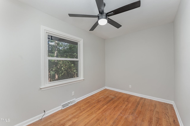 empty room with ceiling fan and light hardwood / wood-style floors