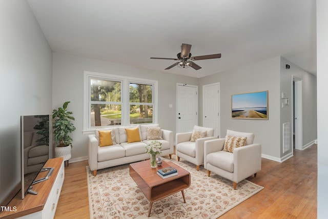 living room featuring light wood-type flooring and ceiling fan