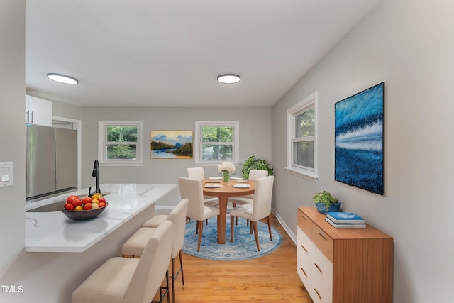 dining space with light hardwood / wood-style floors