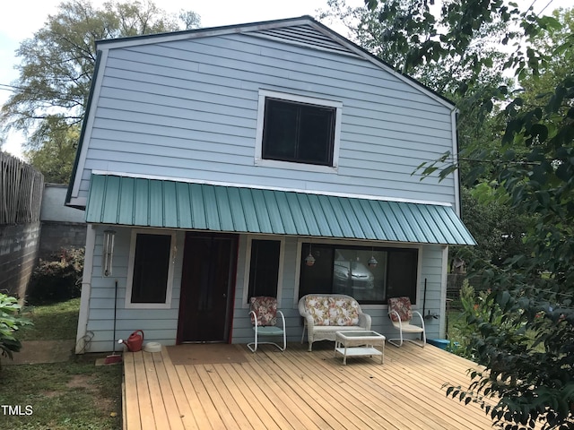 rear view of house with metal roof