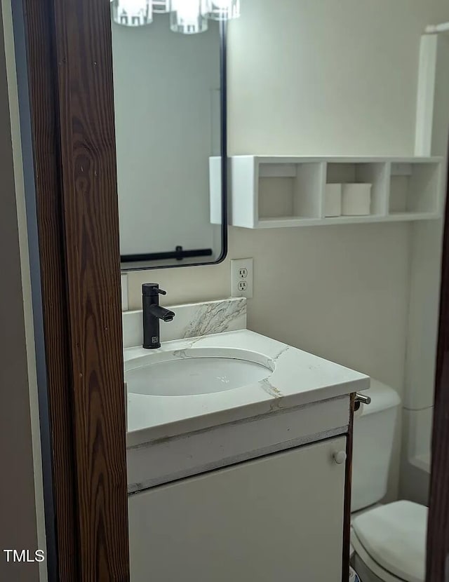 bathroom featuring vanity and toilet