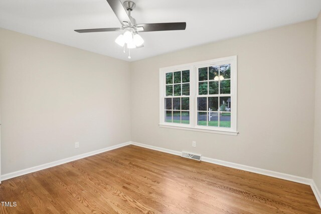 spare room with light wood-type flooring and ceiling fan