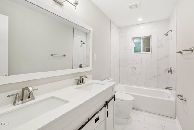 full bathroom with vanity, toilet, and tiled shower / bath combo