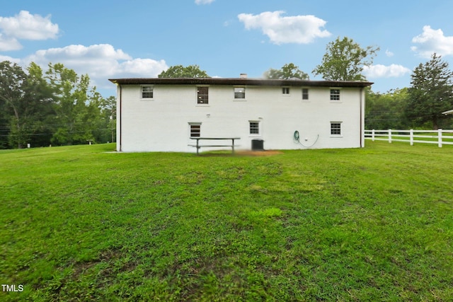 rear view of house with a lawn