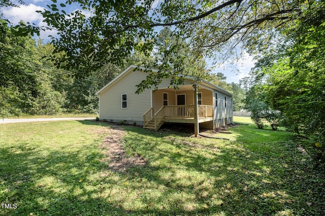 rear view of property featuring a lawn