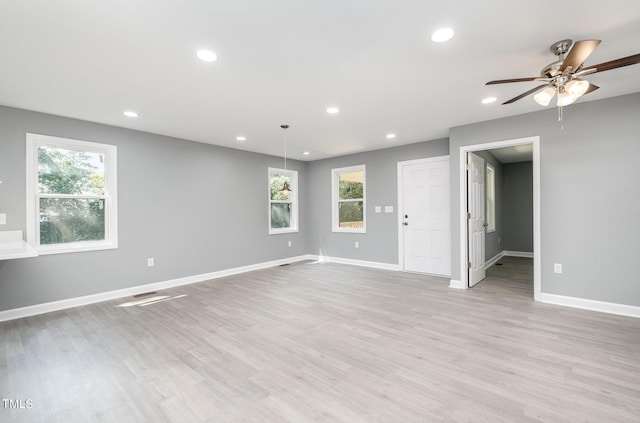 unfurnished room with light wood-type flooring and ceiling fan