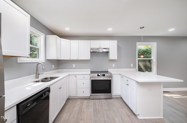 kitchen featuring kitchen peninsula, stainless steel electric stove, sink, decorative light fixtures, and black dishwasher