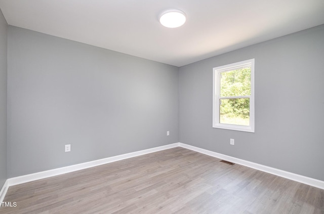 empty room with light hardwood / wood-style flooring