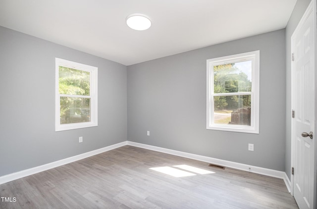 empty room with light hardwood / wood-style floors