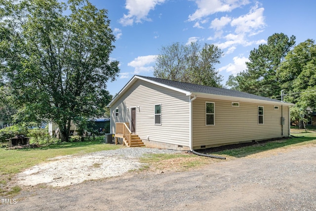 view of side of property with a yard and cooling unit