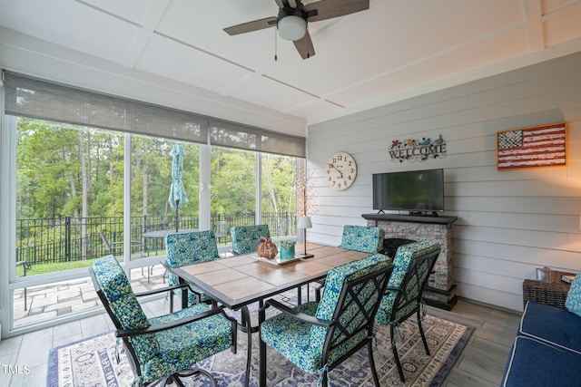 sunroom / solarium featuring ceiling fan and a healthy amount of sunlight