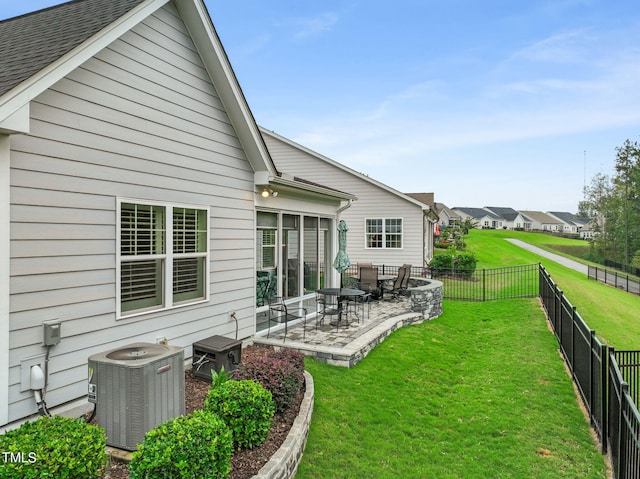 back of property featuring a patio area, a lawn, and central air condition unit