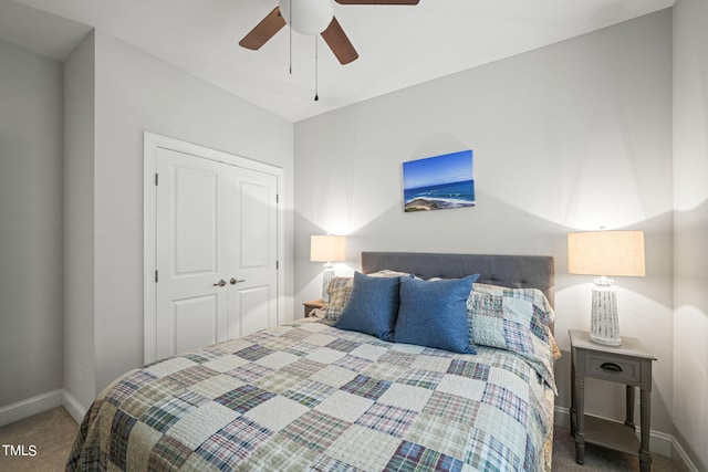 carpeted bedroom featuring ceiling fan and a closet