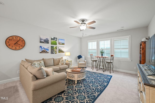 living room featuring light carpet and ceiling fan