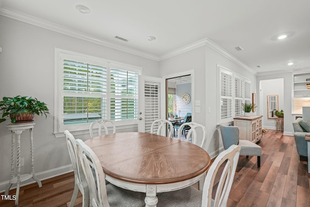 dining room with crown molding and dark wood-type flooring