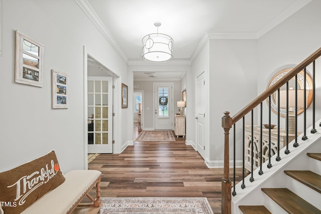 foyer entrance featuring dark wood-type flooring and ornamental molding