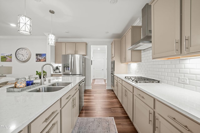 kitchen with pendant lighting, sink, wall chimney exhaust hood, dark wood-type flooring, and appliances with stainless steel finishes