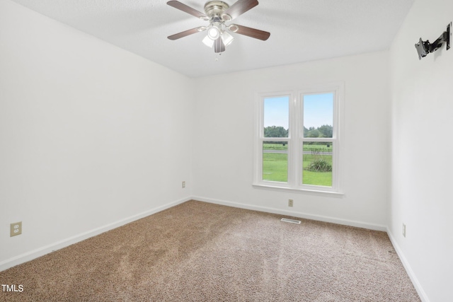 unfurnished room featuring ceiling fan and carpet floors