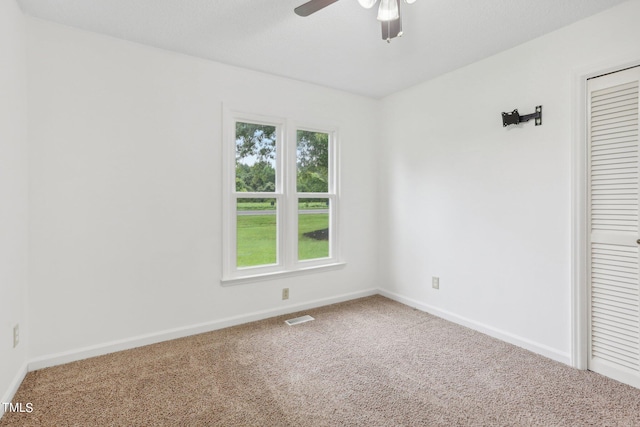 carpeted empty room with ceiling fan